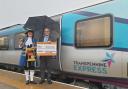 Sharon Wilson, Saltburn's town crier and councillor Cliff Foggo celebrate new TPE rail link