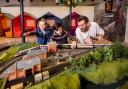 Broadcaster and railway historian Tim Dunn adds the finishing touches to a Hornby model train set featuring Flying Scotsman and an LNER Azuma train, with Holly, age 5, and Miles Trainor-McFerran, age 10 Picture: LNER