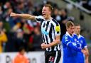Dan Burn celebrates after scoring Newcastle United's opening goal against Leicester City on Tuesday evening