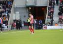 Luke O'Nien leaves the field following his dismissal against Swansea