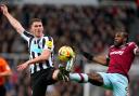 Newcastle United defender Sven Botman challenges for the ball with Michail Antonio