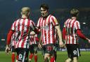 Luke O’Nien and Alex Pritchard lead the celebrations after Sunderland’s opening goal against QPR on Tuesday evening