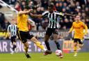 Alexander Isak holds off Max Kilman during Newcastle's win over Wolves