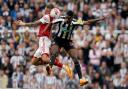 Alexander Isak challenges for the ball with Jakub Kiwior during Newcastle United's 2-0 defeat to Arsenal