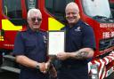 John Pate is pictured receiving a certificate from Chief Fire Officer Chris Lowther at TWFRS Service Headquarters in Washington.