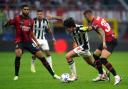 Sandro Tonali tries to break between two AC Milan players
