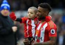 Bradley Lowery being carried onto the pitch by his hero and  charity supporter Jermain Defoe before