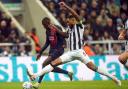Jamaal Lascelles tackles Ousmane Dembele during Newcastle's Champions League win over Paris St Germain