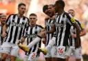 Newcastle United's players celebrate after the opening goal in their 3-0 victory at Sunderland