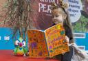 Reception’s Darcee-Mai Laidler shares a book with her new Reading Parrot