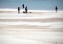 Dog walkers brave a sandstorm on Seaburn beach in Sunderland this morning (SAT) as strong winds hit the North East this weekend, lifting sand into the faces of beachgoers Pictures: North News