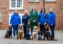 Linda Jones with dog handlers, from left, Karen Keen, Lisa Chorlton, Millie Tinsley, and Kelly Brierley. And dogs, from left, Emmie, Red, Shadow, Chance, Wilma and Axel