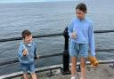 Grace and Harry Liddle getting ready to throw their bottles off the pier