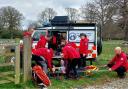 Mountain recue team assist an injured male with injured leg