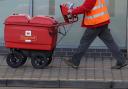 A Royal Mail worker delivering post