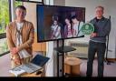 Cllr Phil Eames (right) with historian Ian Trowell (left) and a photo of the Sex Pistols on stage