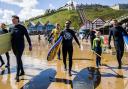 Surfers entering the water at Saltburn Beach.