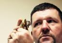 SECONDHAND EXPERT: Valuer Martin Dunn studies an 18-carat gold oyster perpetual, day date, Rolex