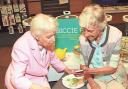 June Whitfield and Moira Kelly, aged 81, with her digital device during the EE Techy Tea Party