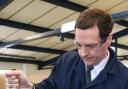 LETTER: Chancellor George Osborne uses a torque wrench to tighten a nut during a visit to an engineering company in Loughborough. A letter signed by 5,000 small firms supporting the Chancellor contains mistakes and duplicate names
