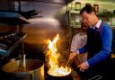 Playing with fire? Nick Clegg making a curry during his visit to a restaurant in Cardiff