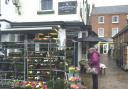 A Sunday shopper looks at bedding plants outside The Greengrocer in Thirsk Market Place