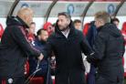 Lee Johnson shakes hand with Manchester United Under 21's boss Neil Wood.