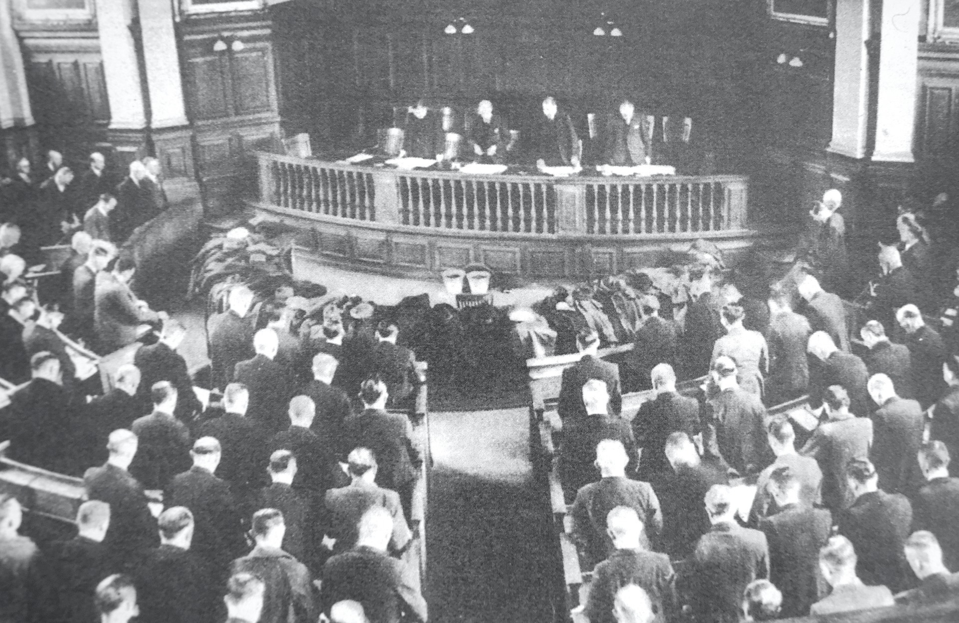 Delegates in the PItman’s Parliament bow their heads in silence, in January 1944, to honour the men killed in Durham’s mines since the previous meeting