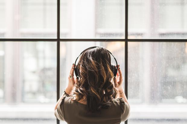 The Northern Echo: A woman listening to music on her headphones. Credit: Canva