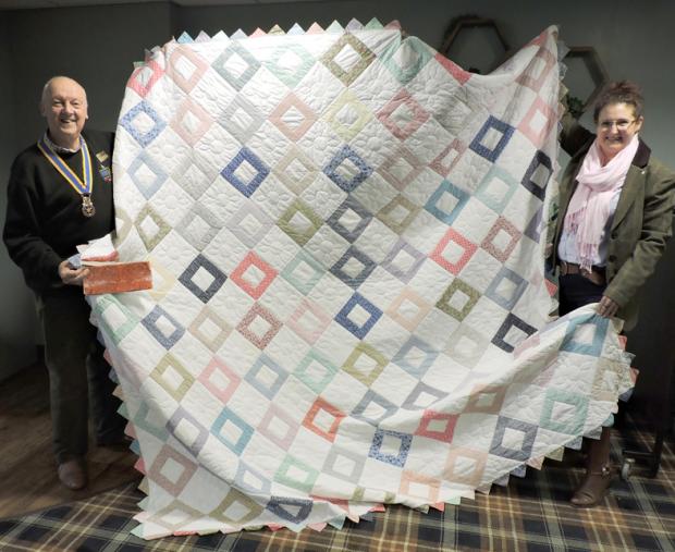 The Northern Echo: Darlington Rotary President, Peter Phillips, with his daughter, Charlotte, and the unique quilt from the USA, stitiched by a traditional Amish community
