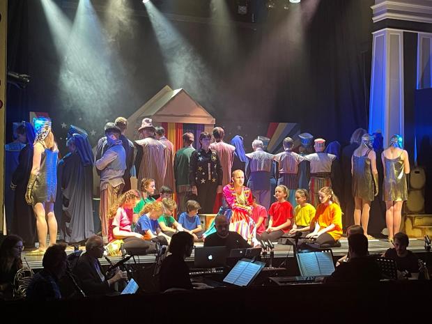 The Northern Echo: Joseph, played by Scott Edwards, with the narrator in black, Karen Davison, surrounded by the cast of Joseph at the Witham Hall, Barnard Castle