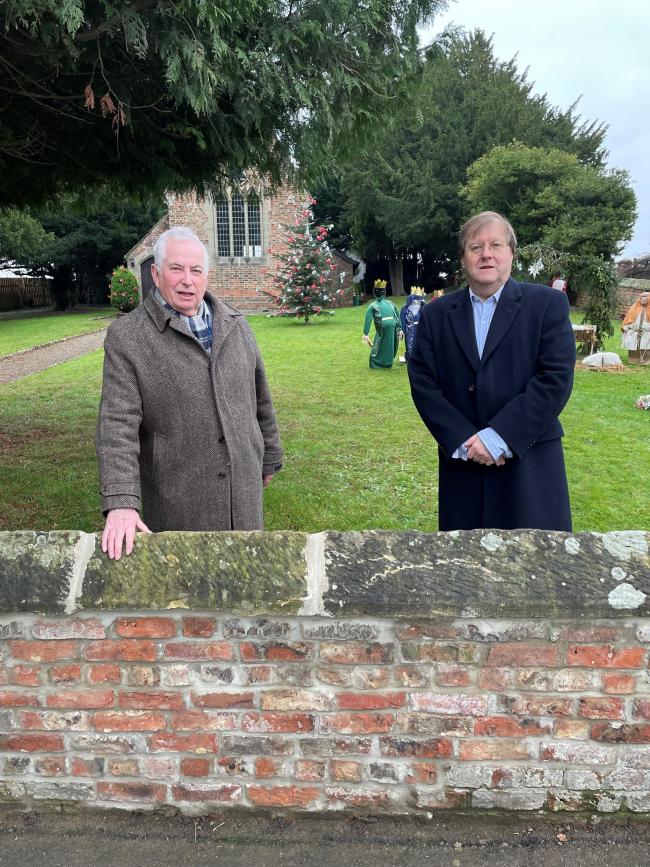 David Armitage and Robert Beaumont by the restored Minskip church wall.