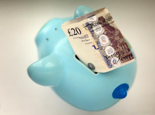 The Northern Echo: Piggy bank with a £20 note. Credit: PA