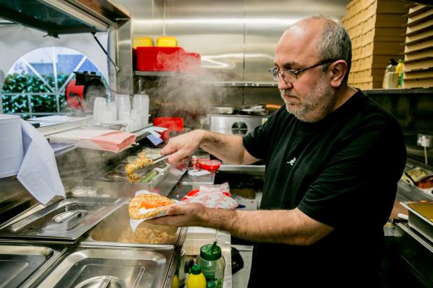 The Northern Echo: Stavros Vouli, the owner of Something Greek, serves up a storm in the kitchen in Newton Aycliffe. Photo: SARAH CALDECOTT.