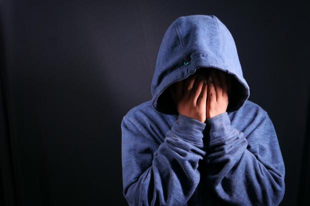 The Northern Echo: A person touching their face wearing a blue hoodie. Credit: Canva