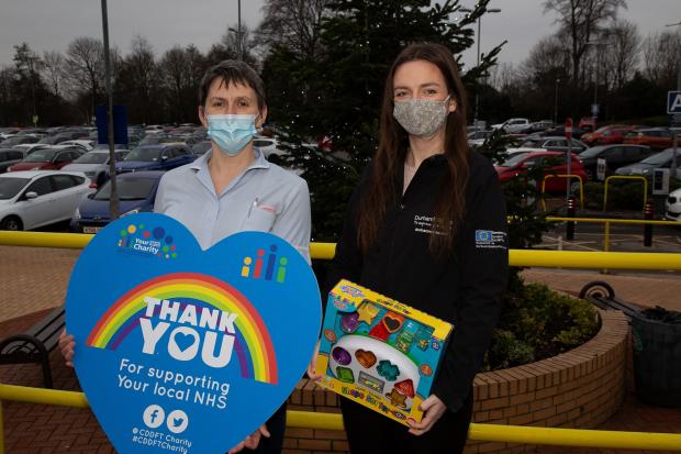The Northern Echo: DurhamWorks employment engagement officer Hannah Fenwick (right), handing over charity donations to play coordinator for University North Durham Hospital’s Tree Tops ward, Jill Boyd (left). Picture: DURHAM COUNTY COUNCIL.