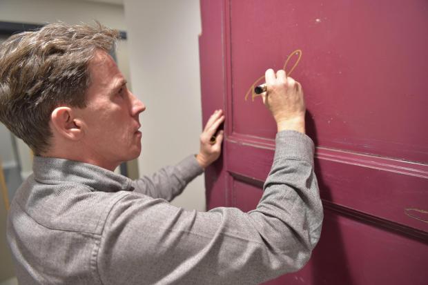 The Northern Echo: Rob Brydon signing a door at The Stockton Globe in October 2021. Picture: STOCKTON GLOBE
