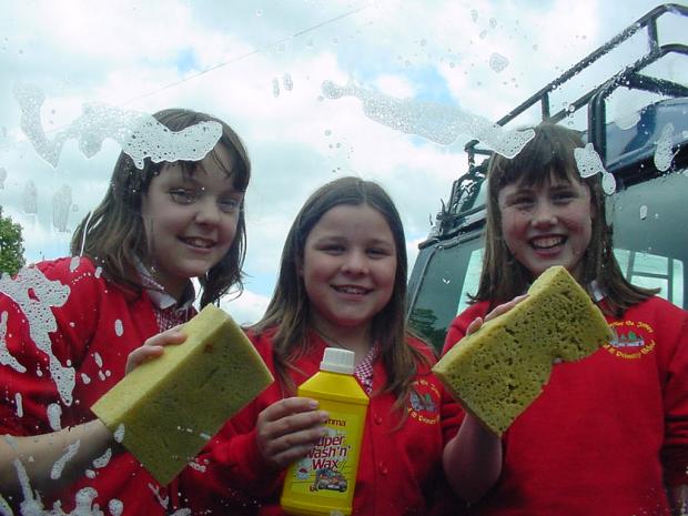 The Northern Echo: Baldersby St James School fundraisrers - Older pupils Charlotte Parker, Gilly Thorne and Katie Utley, who volunteered to wash the car belonging to the highest bidder 27/05/2006