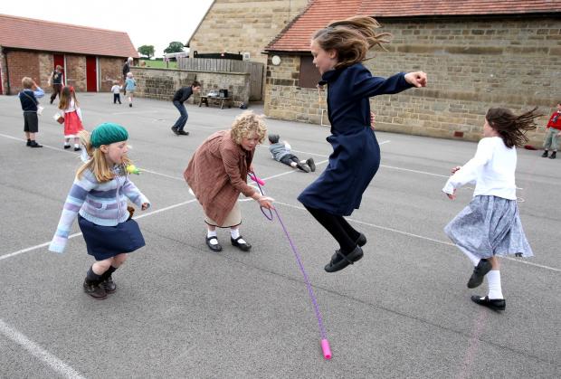 The Northern Echo: Baldersby St James Primary School, nr Thirsk - 1940's event at the school involving staff and pupils dressing in accordance with fashions of the era. Some of the pupils in the playground including Caitlin Fox (10, jumping). – 11/06/2013