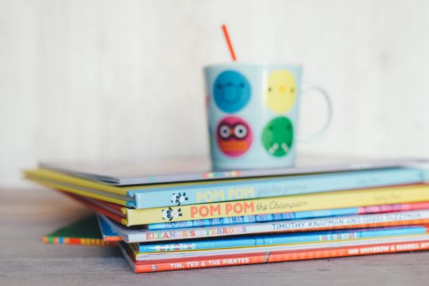 The Northern Echo: Children's books in a pile with a colourful mug on top. Credit: Canva