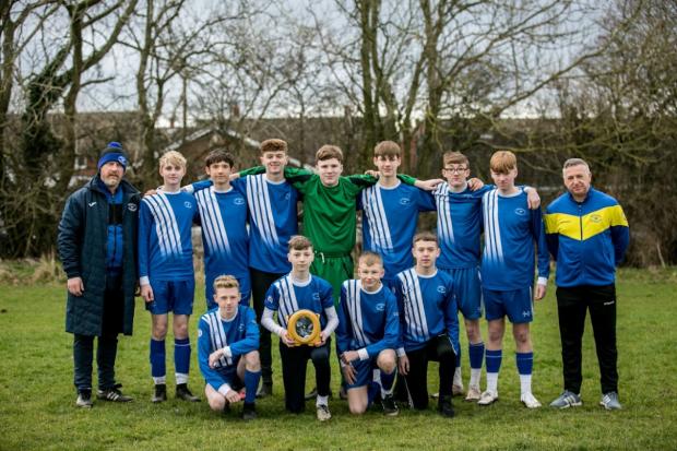 The Northern Echo: Newton Aycliffe U15s with their new defibrillator, donated by London Heart. Picture: SARAH CALDECOTT.