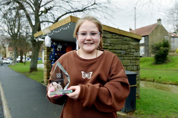 The Northern Echo: Emily Pierson, ten, with her award at the bus stop swap shop in Catterick Village