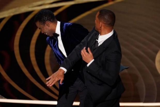 The Northern Echo: Will Smith strikes Chris Rock at last night's Oscars ceremony. Picture: PA MEDIA.