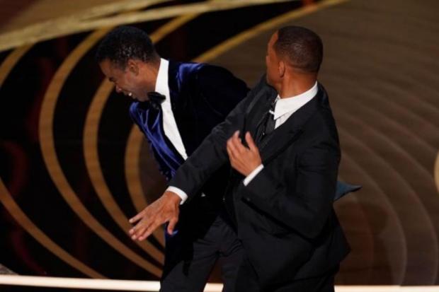 The Northern Echo: Will Smith hits Chris Rock at Sunday's Oscars ceremony. Picture: PA MEDIA.