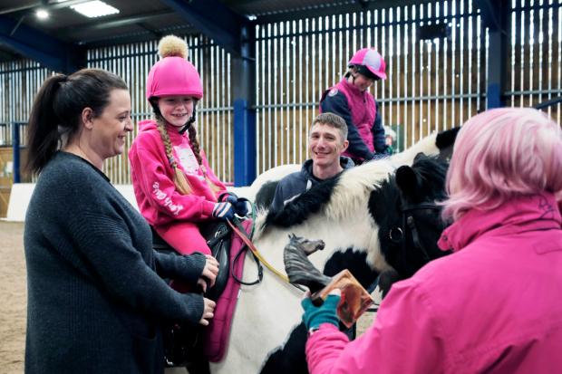 The Northern Echo: 9-year-old Kelsey Power receives the Maggie Tansley Award from North Yorkshire with Cleveland County Chair of the Riding for the Disabled Association Cass O'Brian at Catterick Garrison Saddle Club. Photograph: Stuart Boulton.