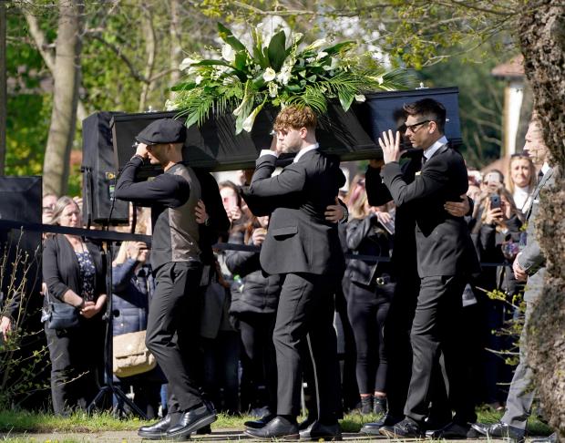 The Northern Echo: Max George (left) and Jay McGuiness of The Wanted (centre) carry the coffin at the funeral of their bandmate Tom Parker. (PA)