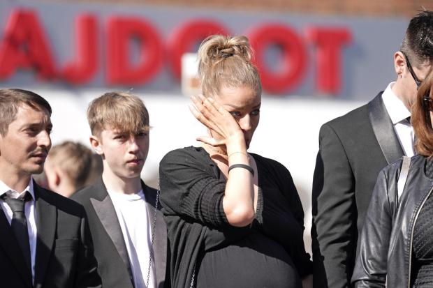 The Northern Echo: Mourners watch as the coffin of The Wanted star Tom Parker is carried ahead of his funeral. (PA)