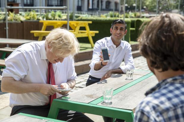 Prime Minister Boris Johnson (left) and the Chancellor of the Exchequer Rishi Sunak (centre), during a visit to the Pizza Pilgrims restaurant in east London.  Picture: PA