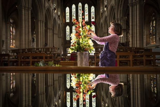 Caroline Baldwin puts the finishing touches to a floral display at Ripon Cathedral in North Yorkshire, that forms part of a celebration of the life and legacy of Ripon Cathedral's founding father, Wilfrid Picture: PA
