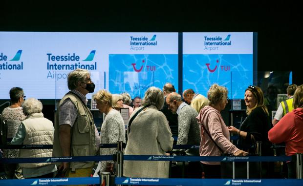 The Northern Echo: Passengers queue ahead of their flight on Tuesday. Picture: SARAH CALDECOTT